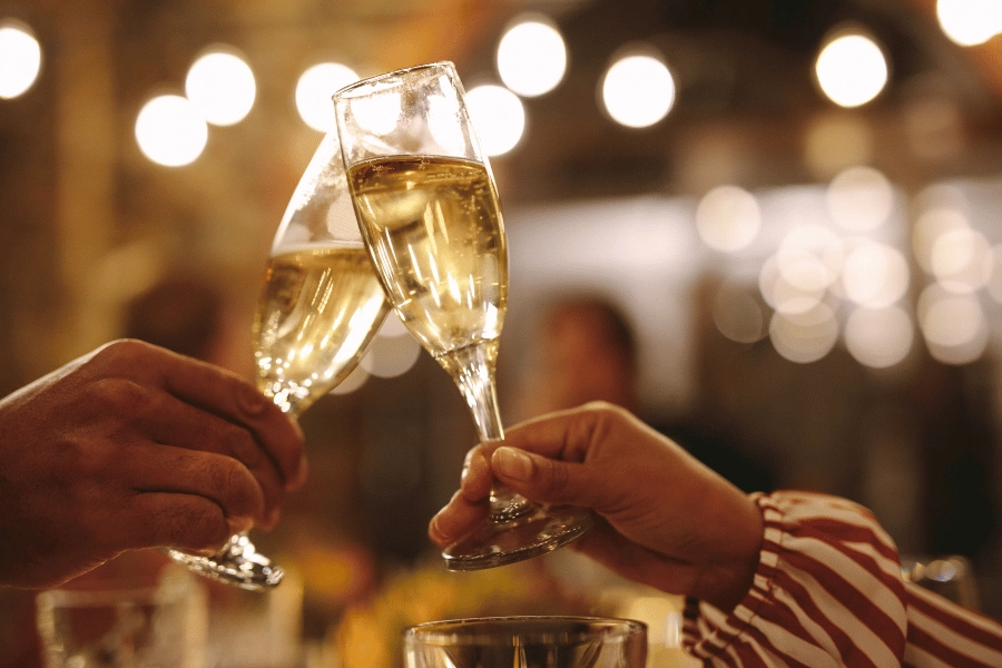 couple doing a champagne toast at dinner to ring in the new year